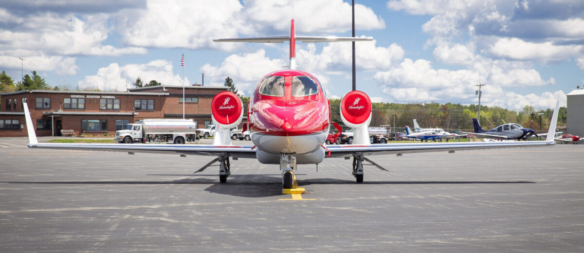 photo of red and white jet sitting on runway