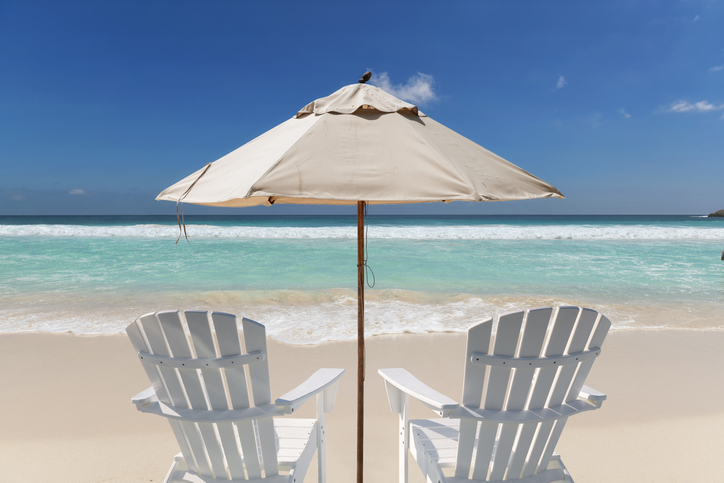 Chairs and umbrella in vacations tropical beach. Summer vacation and tropical beach concept.